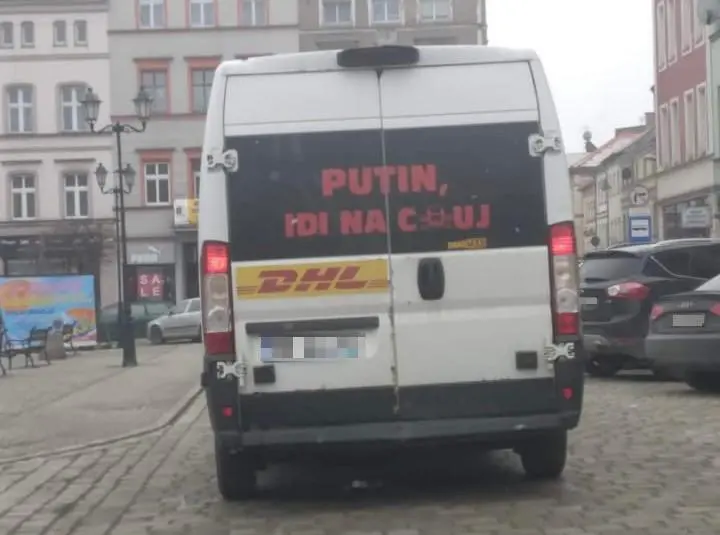 A DHL delivery van with Putin go fuck yourself in russian written on it’s back window